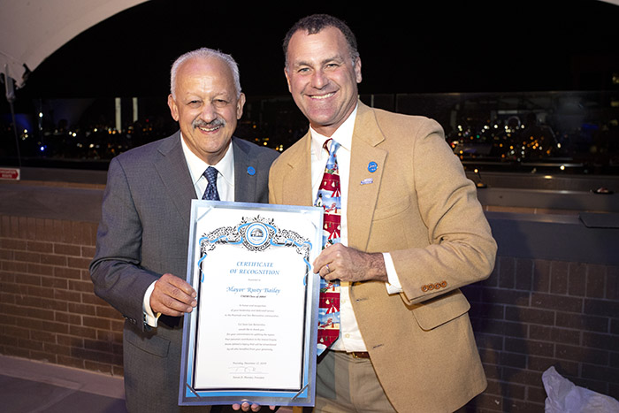CSUSB President Tomás D. Morales (left) presents to Riverside Mayor Rusty Baily, a CSUSB graduate, a signed certificate of recognition 