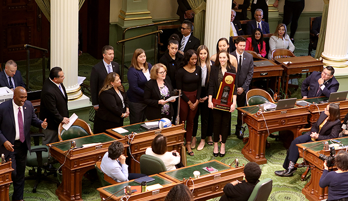 The team on in the Assembly chamber, introduced by Assemblymember Eloise Gómez Reyes 
